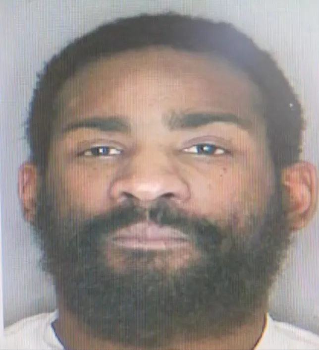 Headshot of a Black man with a beard, looking at the camera.