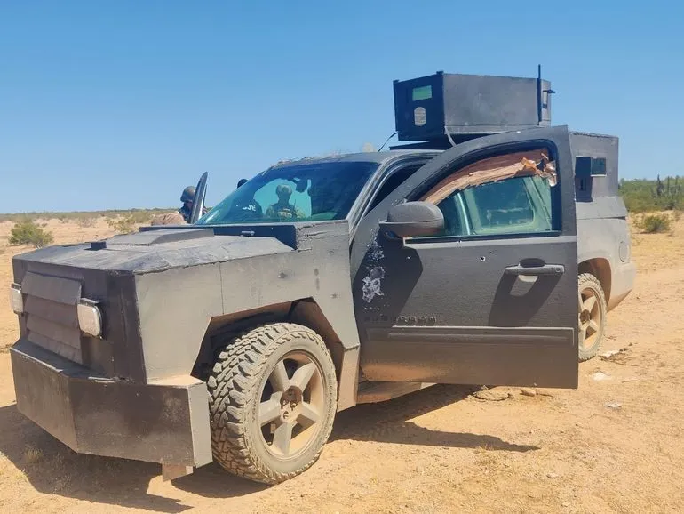 A heavily modified black armored vehicle, known as a