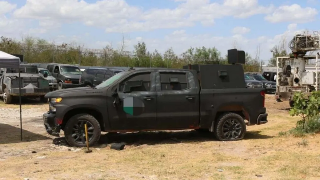 An armored black pickup truck parked outdoors.