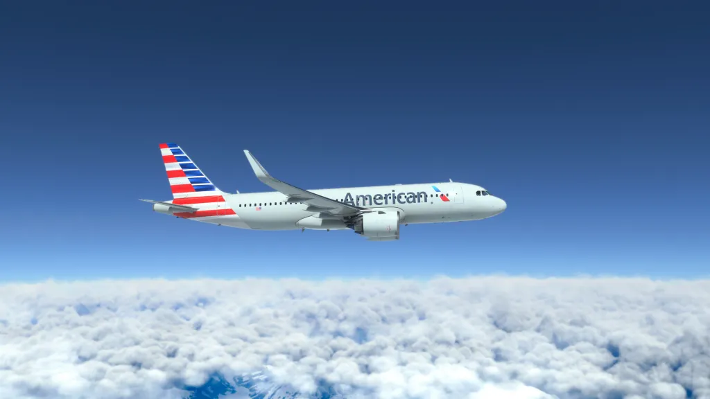An American Airlines Airbus A320 flies in the blue sky above a layer of white clouds.