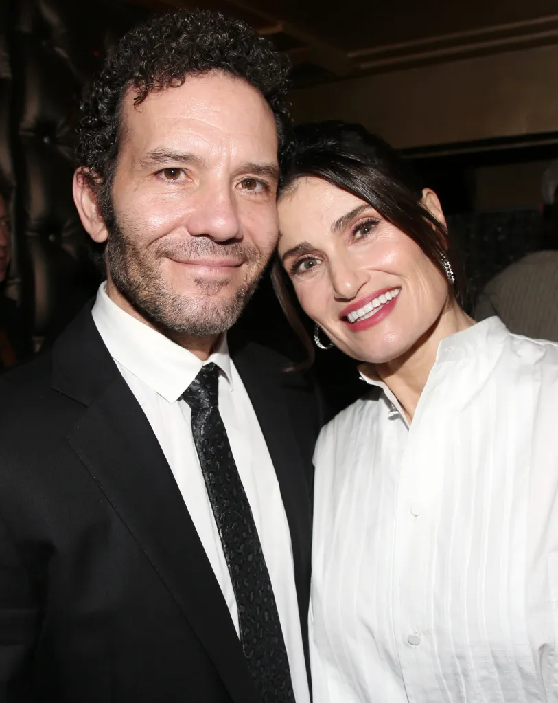 Aaron Lohr and Idina Menzel pose together at an event.