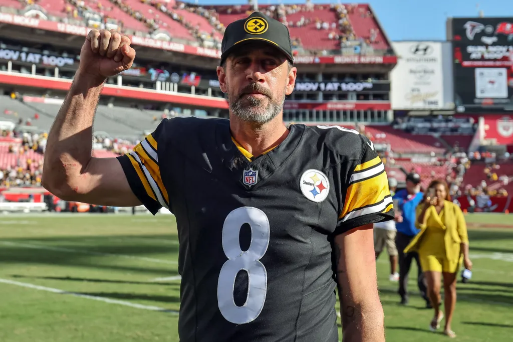 Aaron Rodgers #8 of the Pittsburgh Steelers acknowledges the crowd after an overtime win against the Tampa Bay Buccaneers at Raymond James Stadium.