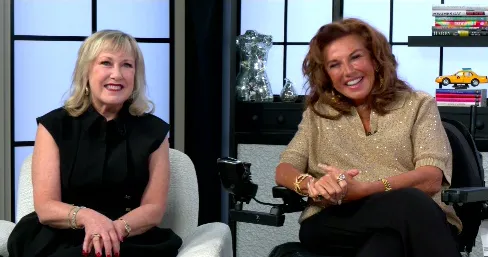 Abby Lee Miller and Cathy Nesbitt-Stein smiling while sitting together.