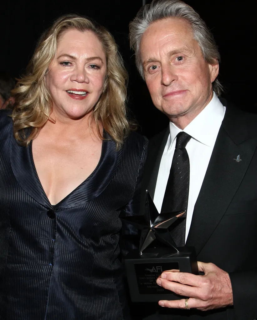 Actress Kathleen Turner and actor Michael Douglas pose backstage, with Douglas holding the Life Achievement In Motion Pictures and Television award.