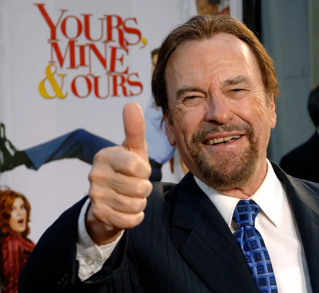 Actor Rip Torn smiling and giving a thumbs up at the premiere of 