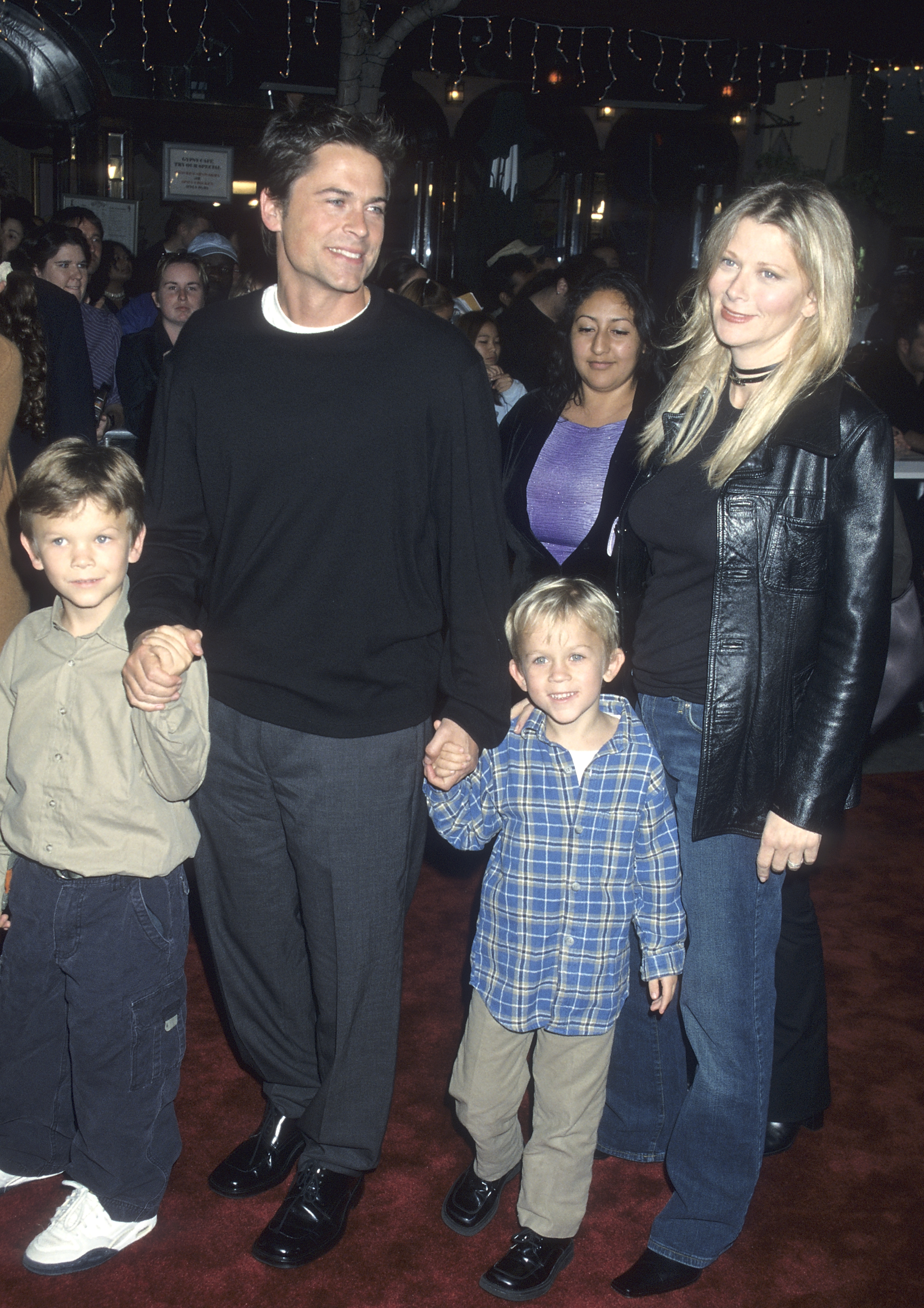 Actor Rob Lowe and his wife Sheryl Berkoff pose with their children on a red carpet.