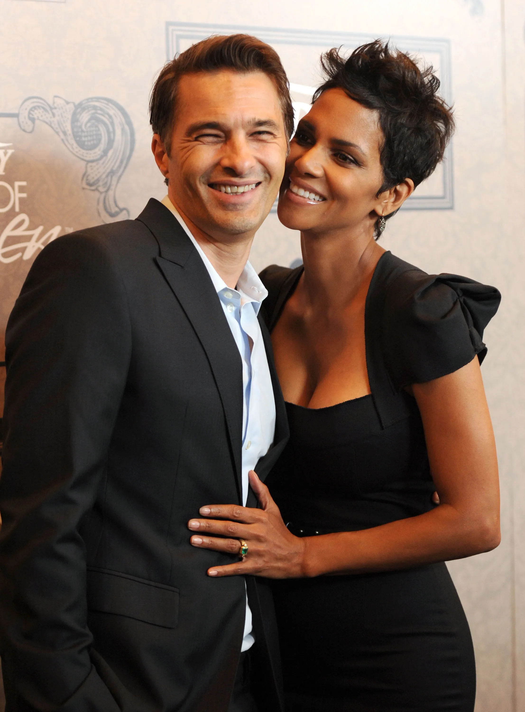 Actors Olivier Martinez and Halle Berry pose together, smiling at an event.
