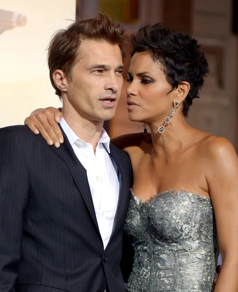 Actress Halle Berry and actor Olivier Martinez arrive at a movie premiere.