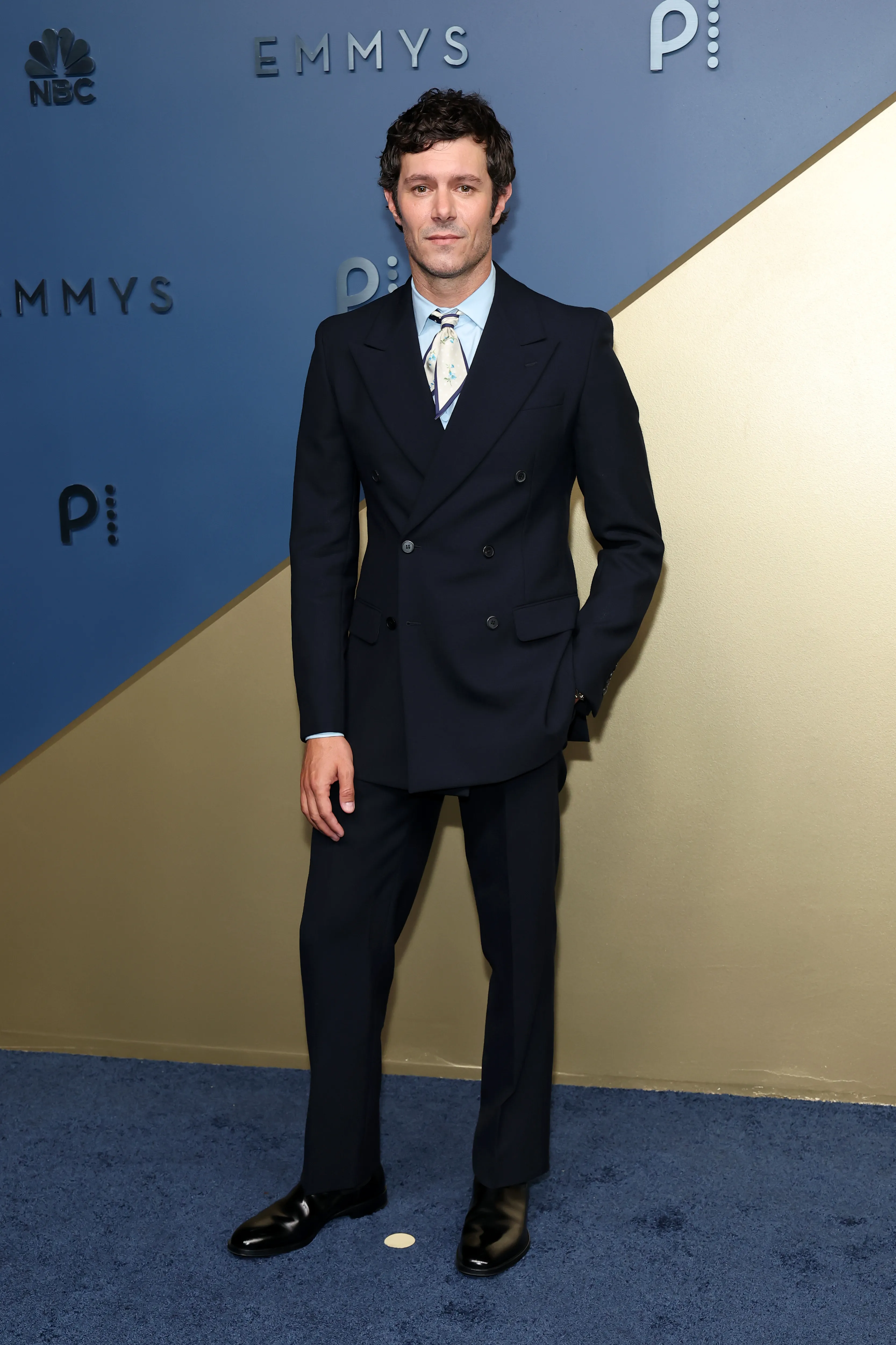 Adam Brody in a navy blue double-breasted suit at the 78th Primetime Emmy Awards.