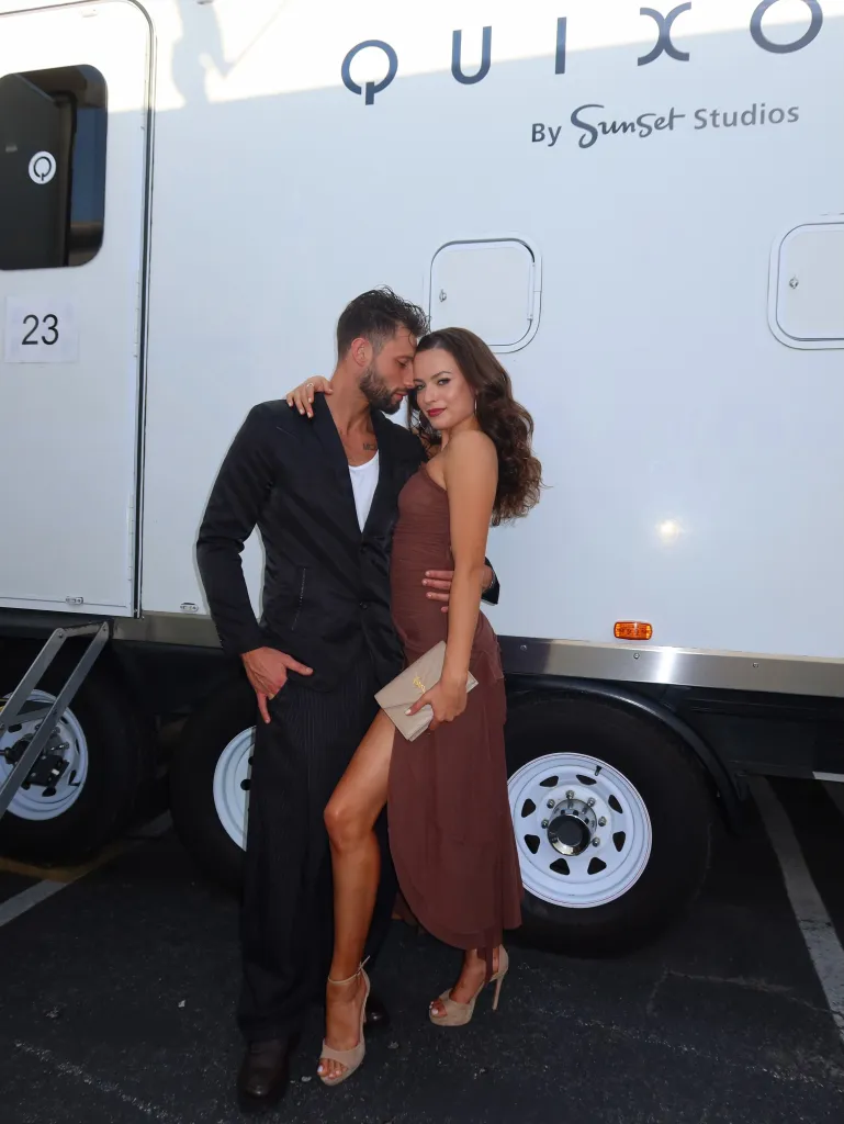 Adele Zaikman and Allen Genkin pose together in front of a white trailer.