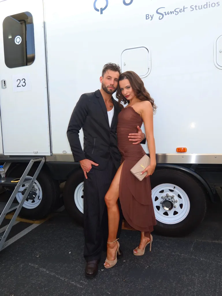 Adele Zaikman and Allen Genkin pose together in front of a white trailer.