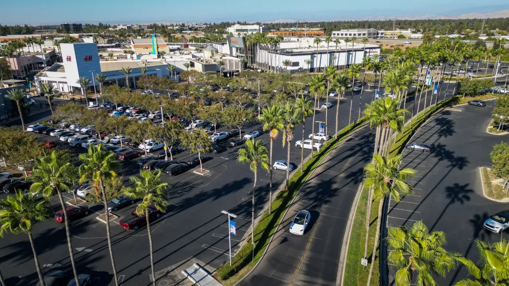 Aerial view of the River Park shopping center surrounded by palm trees in Fresno.