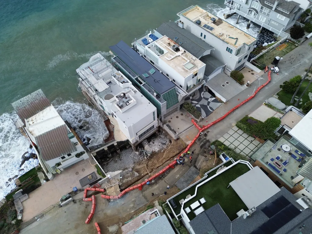 Aerial view of a sinkhole beneath a beachfront mansion in Malibu.
