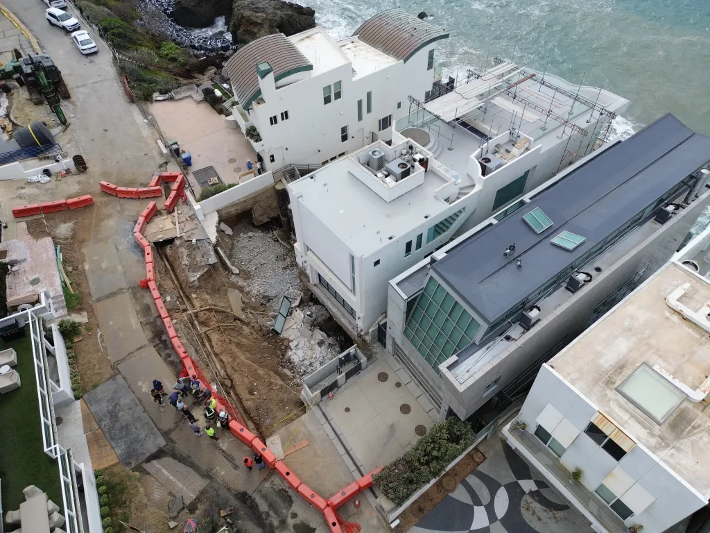 Aerial view of a sinkhole near a beachfront mansion in Malibu, CA.