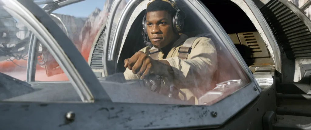 John Boyega as Finn piloting a spacecraft in Star Wars: The Last Jedi.