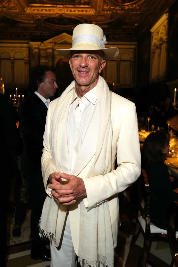 Alan Faena wearing a white suit and fedora at a charity gala in Venice.