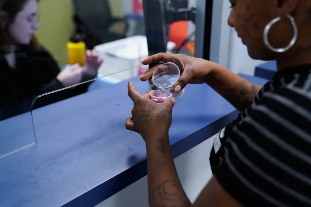 Alicia Bermudez adds water to her Methadone in small plastic cups at Community Medical Services.