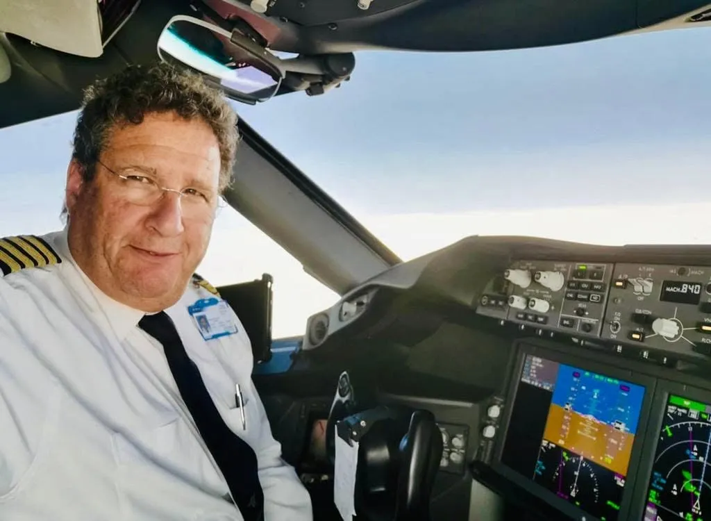Alon Pereg sitting in the cockpit of an airplane.
