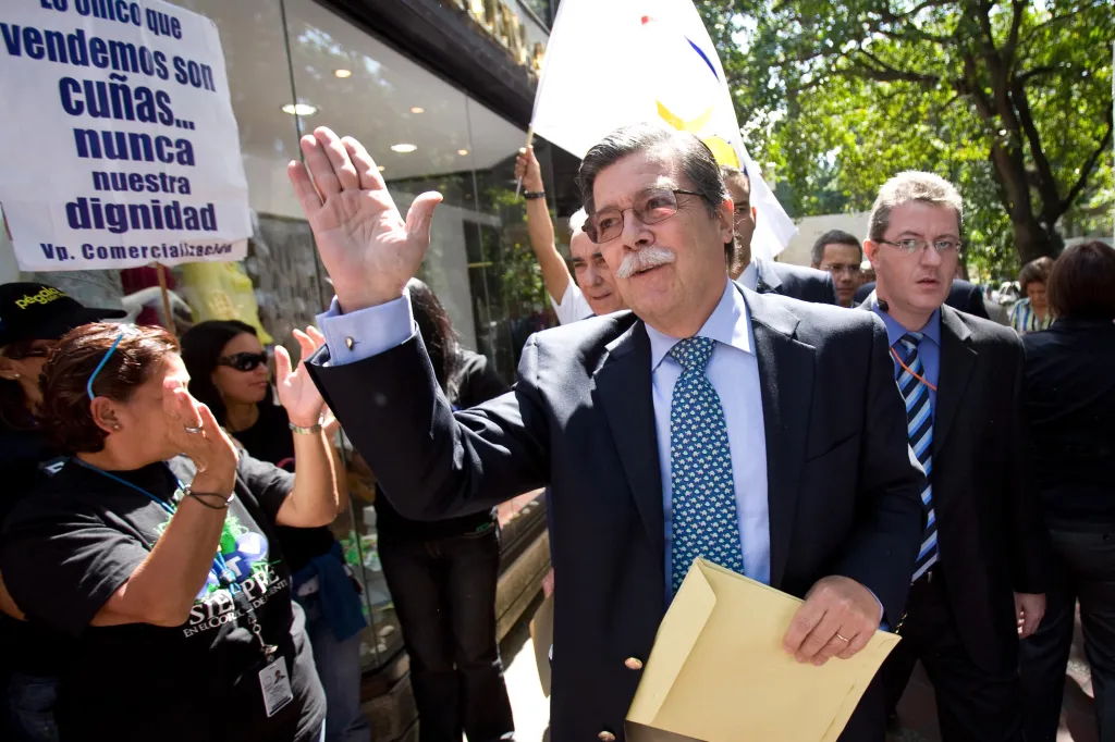 Marcel Granier, director of the Venezuelan RCTV private broadcast, waves to supporters outside.