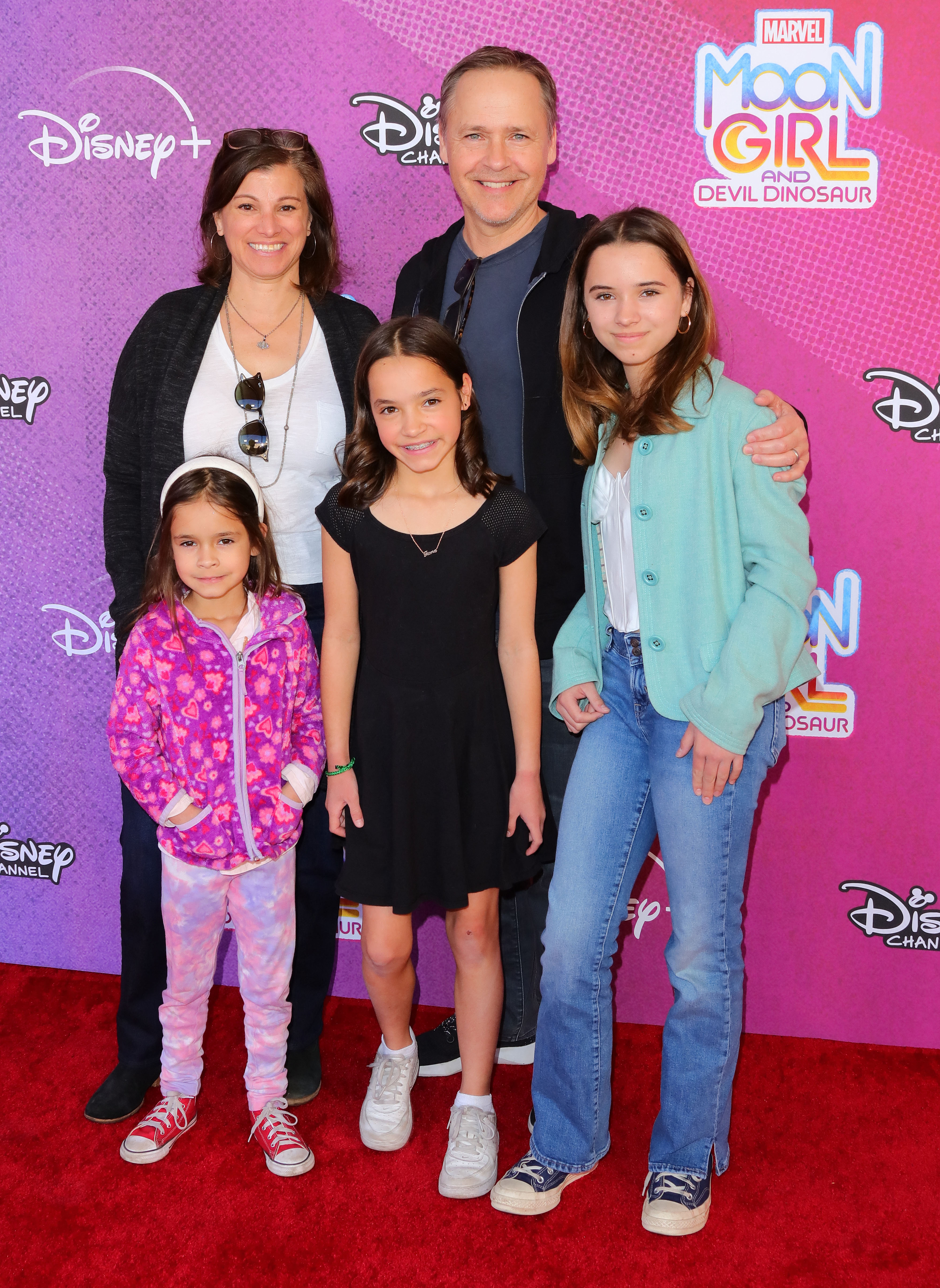 Actor Chad Lowe, his wife Kim Painter, and their three daughters, Nixie, Fiona, and Mabel, posing together on a red carpet.