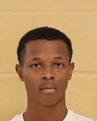 Booking photo of Alonzo Abbott against a neutral background.