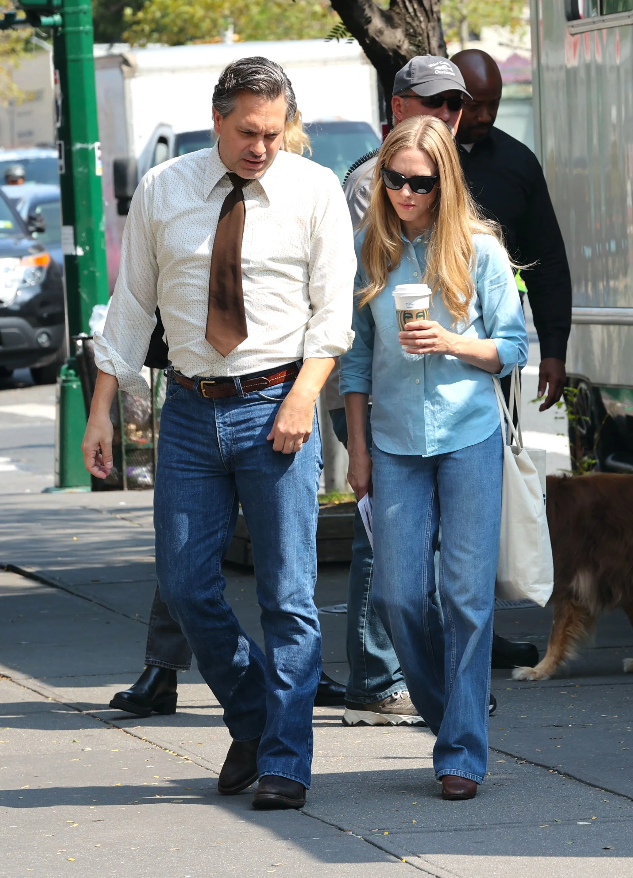 Amanda Seyfried and Thomas Sadoski walk on a city sidewalk.
