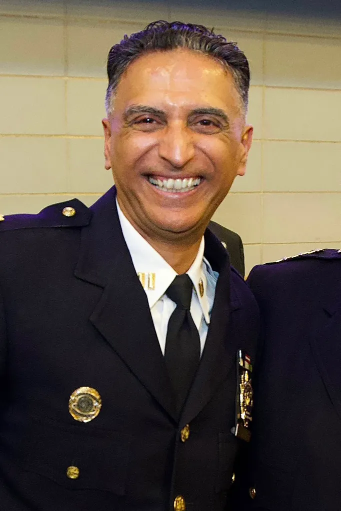 Deputy Inspector Amanjeet S. Sandhu in uniform smiling.