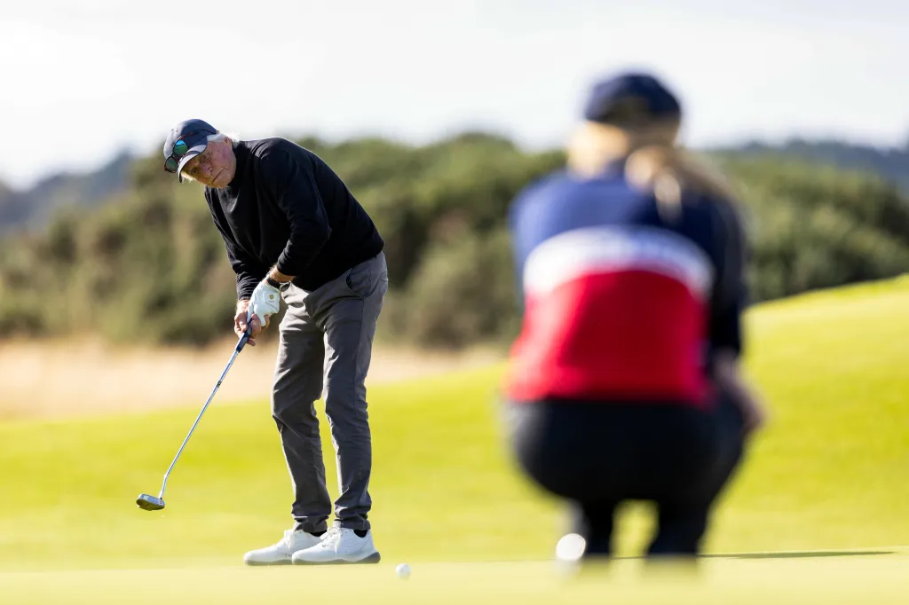 Michael Douglas plays golf on a course during the Alfred Dunhill Links Championship.