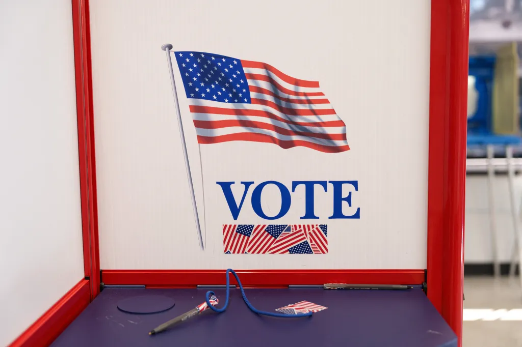 An American flag decorates a voting booth at a polling station.