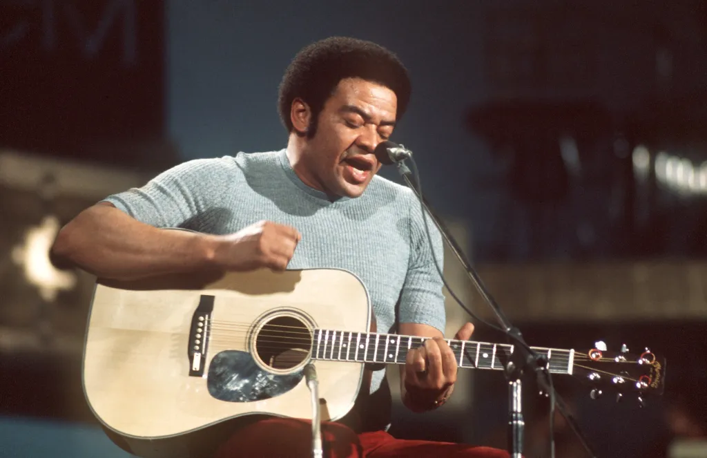 American singer, guitarist and songwriter Bill Withers performing on stage.