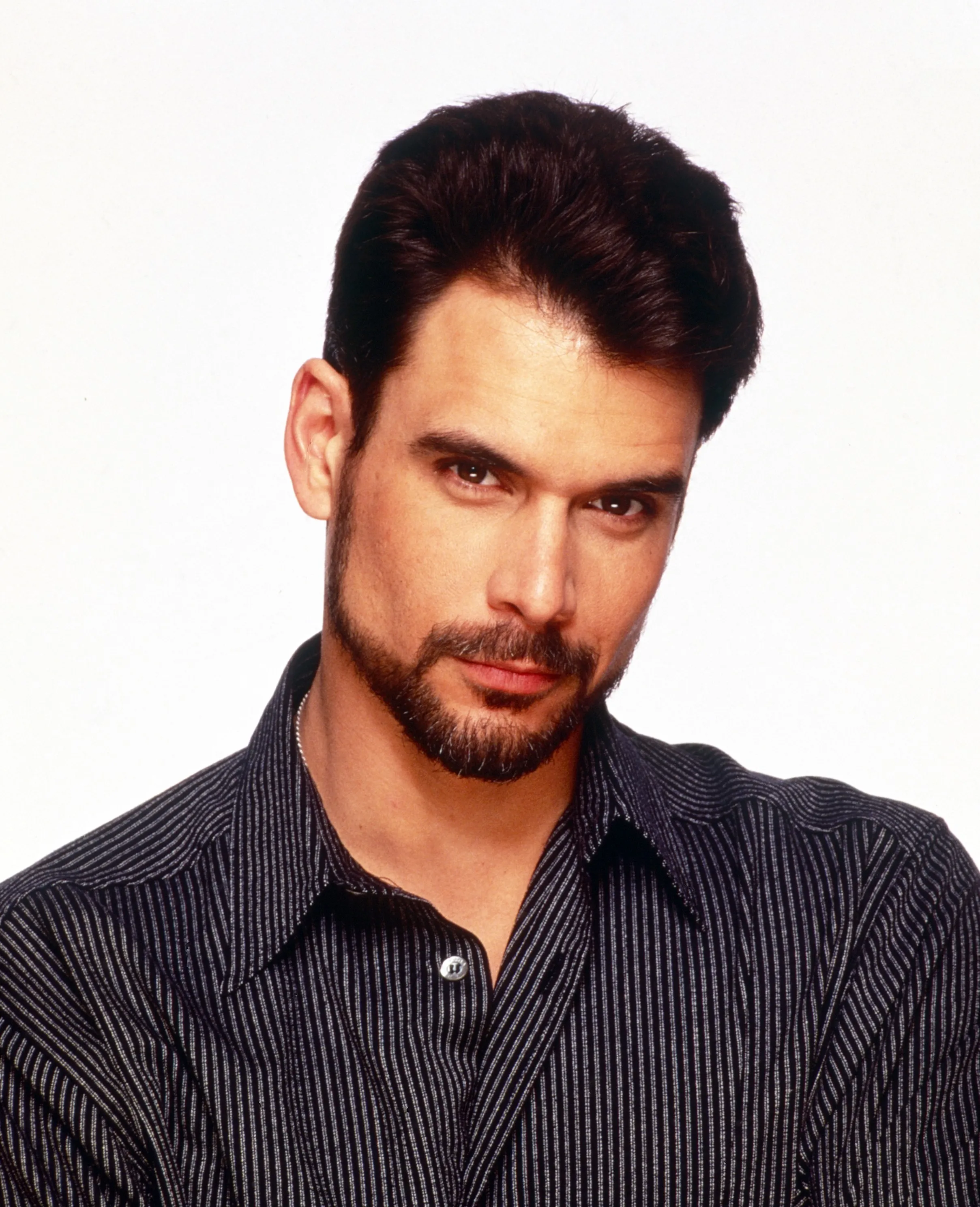 Portrait of Robert Kelker-Kelly wearing a black striped shirt.