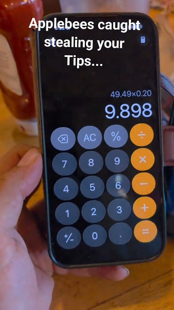 A smartphone displaying a calculator app with the equation 49.49 x 0.20 equaling 9.898, with overlaid text reading