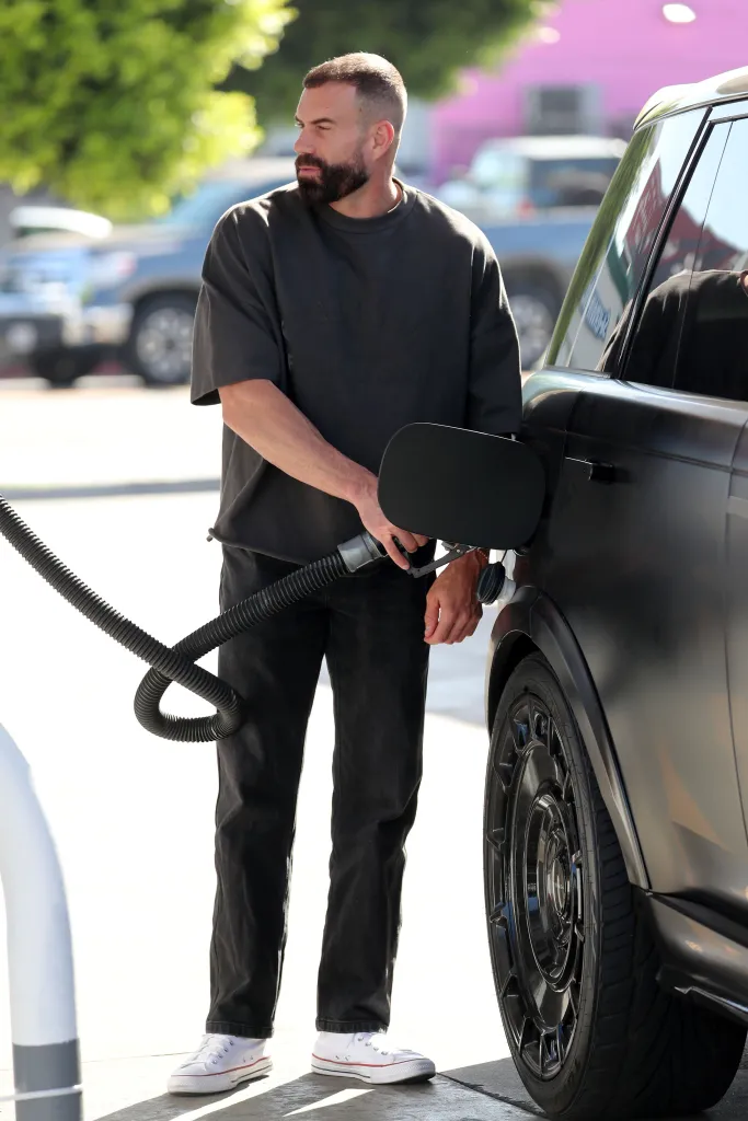 A man pumping gas into his car at a station in Los Angeles.