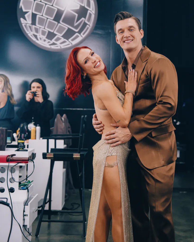 Sharna Burgess and Tyler Cameron pose together backstage on Dancing with the Stars.
