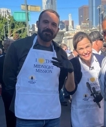 Ben Affleck and Jennifer Garner wearing matching aprons at a community food drive in downtown Los Angeles.