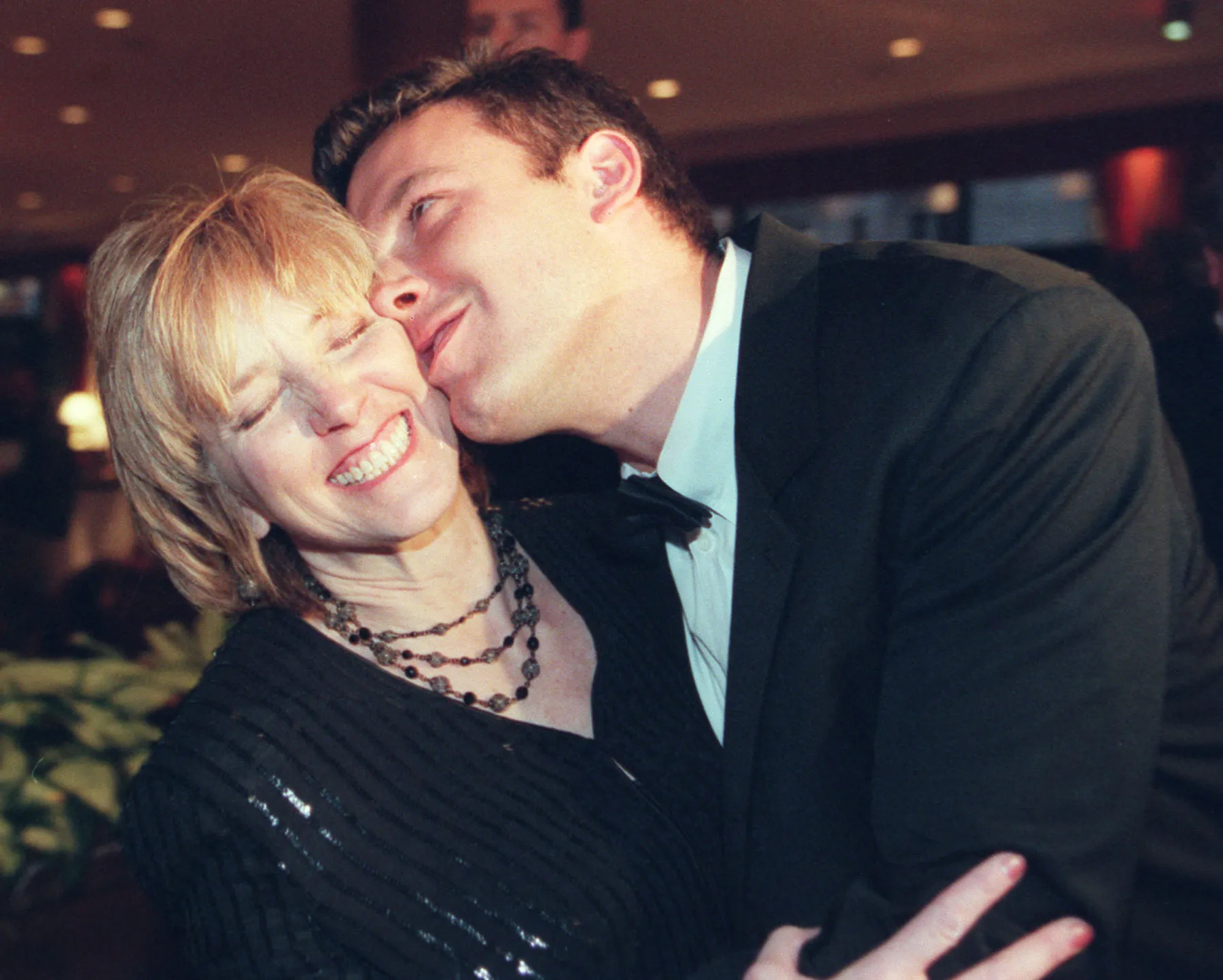 Ben Affleck kisses his mother Chris Affleck on the cheek.