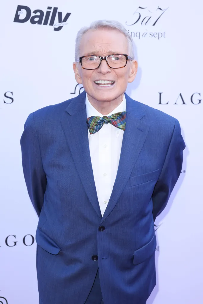 Fashion designer Bob Mackie wearing a blue suit and plaid bowtie.