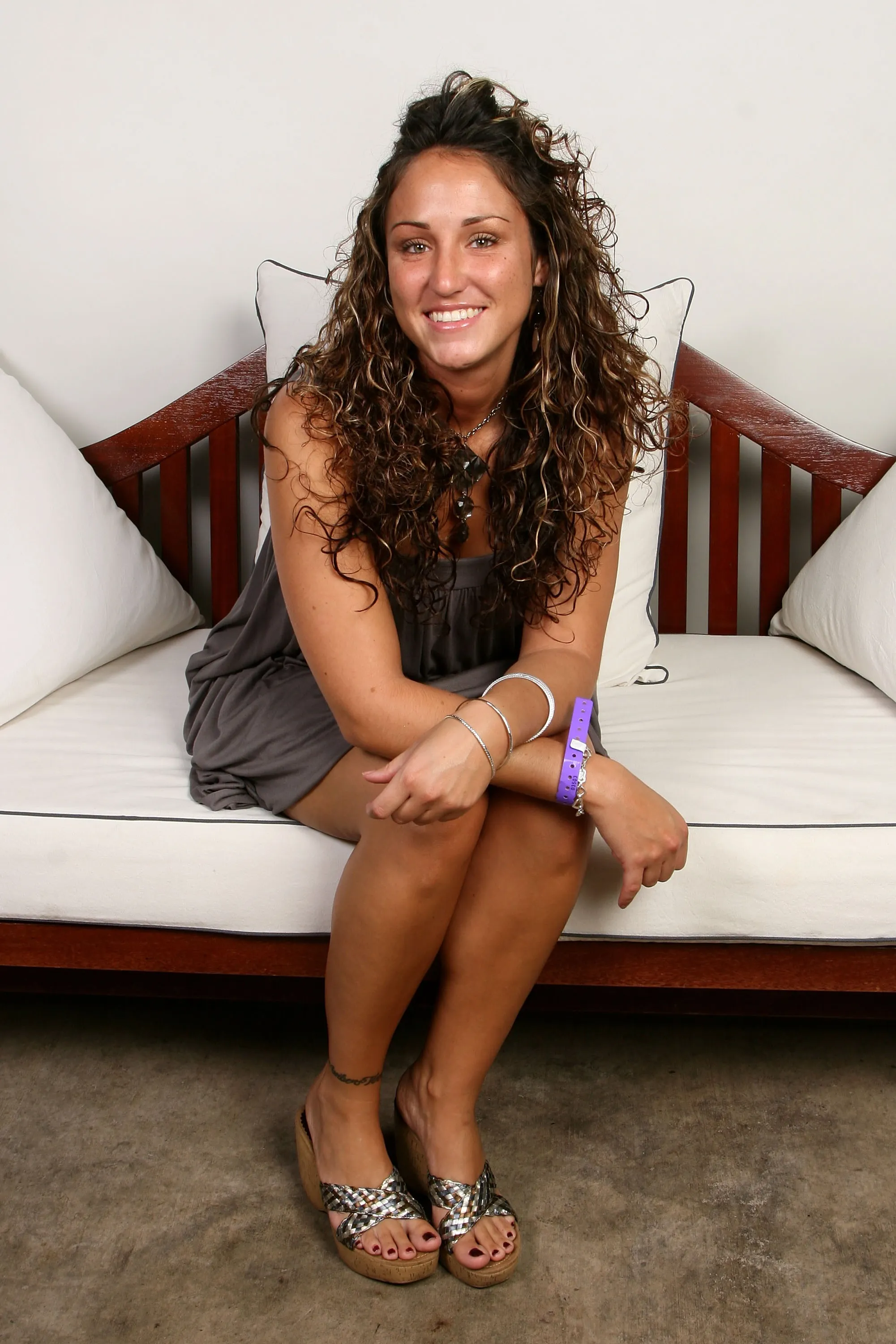 Portrait of Amber Siyavus sitting on a couch.