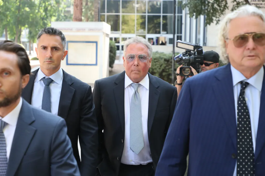 Billionaire Stephen Cloobeck arrives at Los Angeles Superior Court flanked by attorneys.