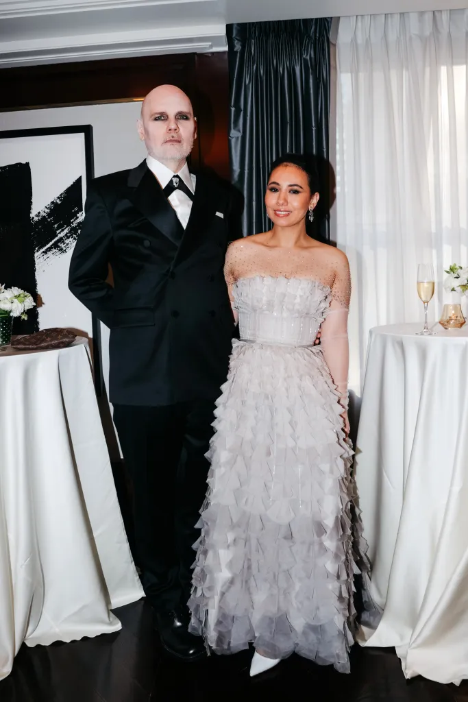 Billy Corgan and Chloe Mendel Corgan pose for a photo.