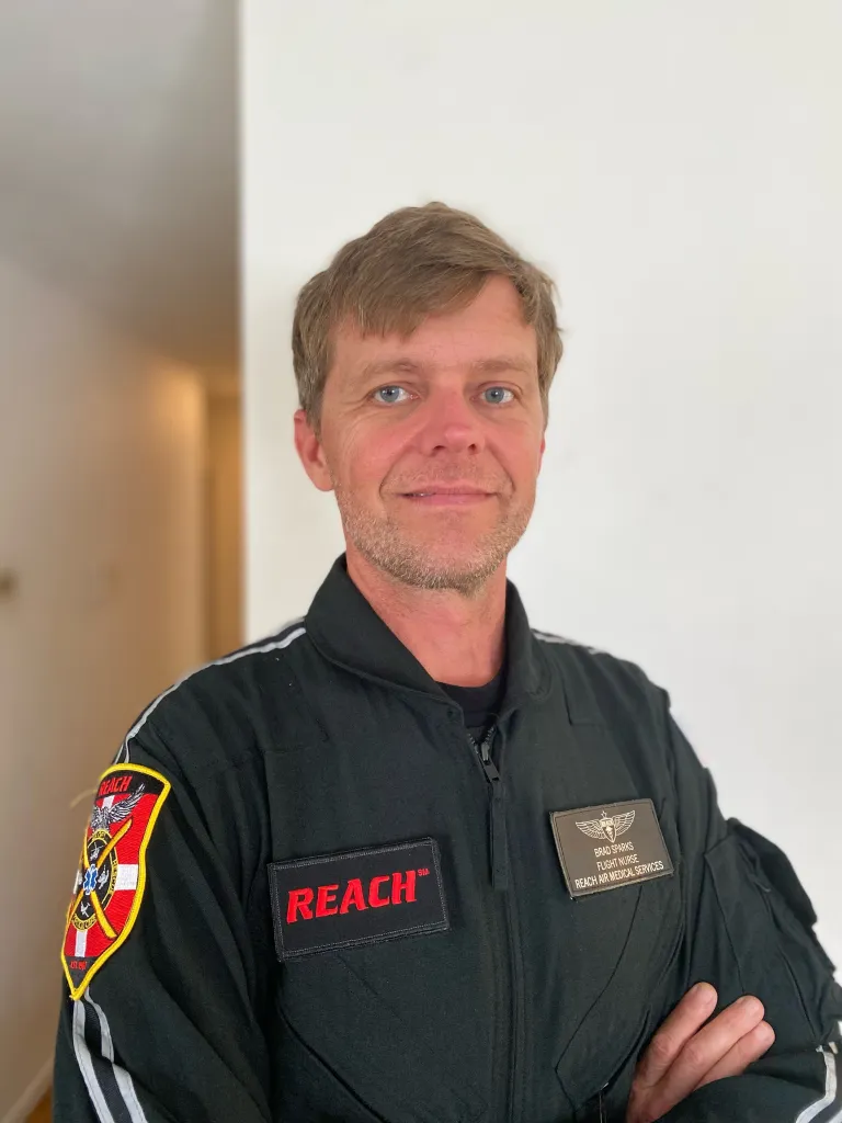Brad Sparks in a black flight suit.