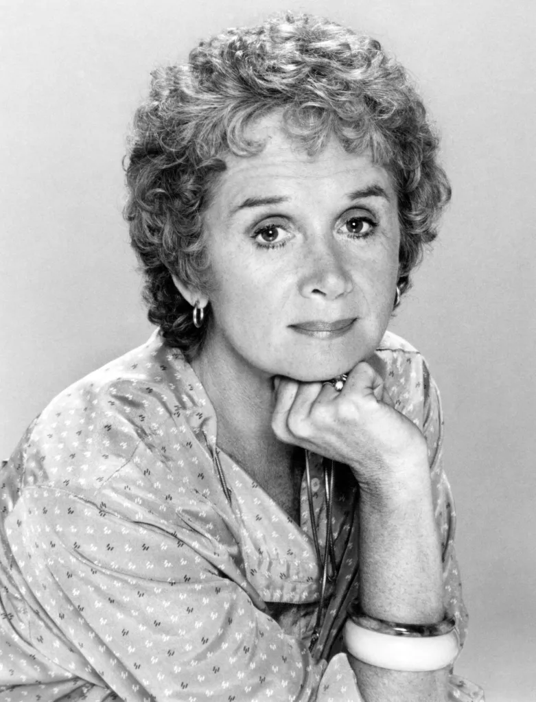 Black and white portrait of actress Barbara Barrie with her chin resting on her hand.