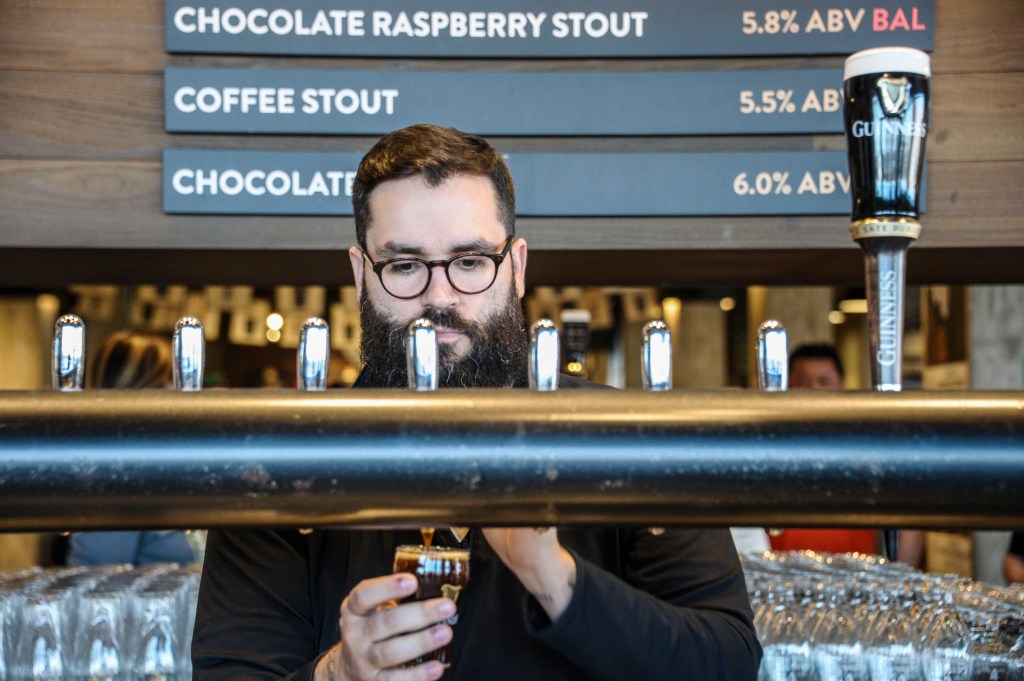 Brewery Ambassador Ryan Wagner pours a glass of local Stout at the Guinness Open Gate Brewery in Baltimore.