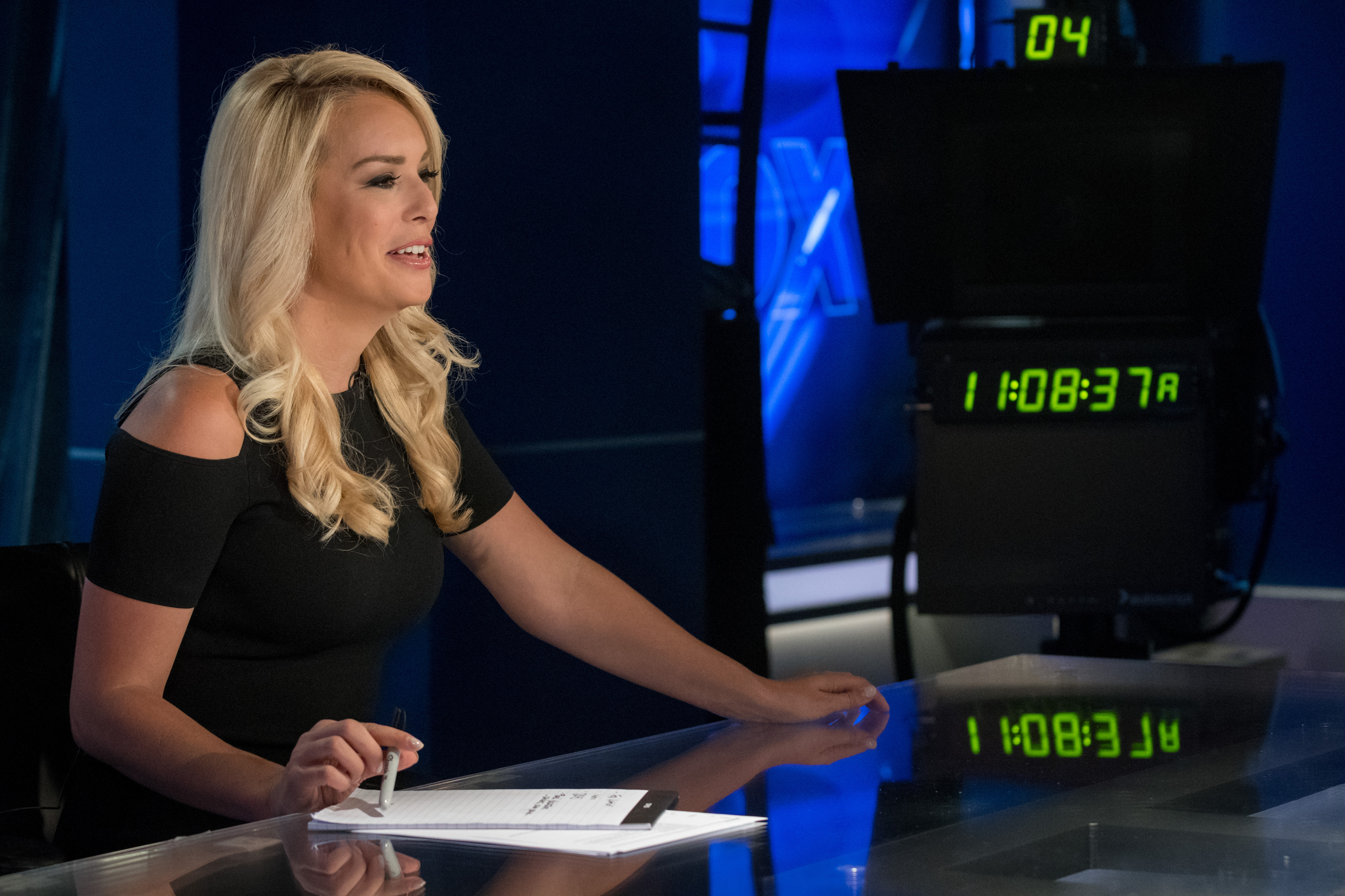 Britt McHenry sitting at the Fox news set.