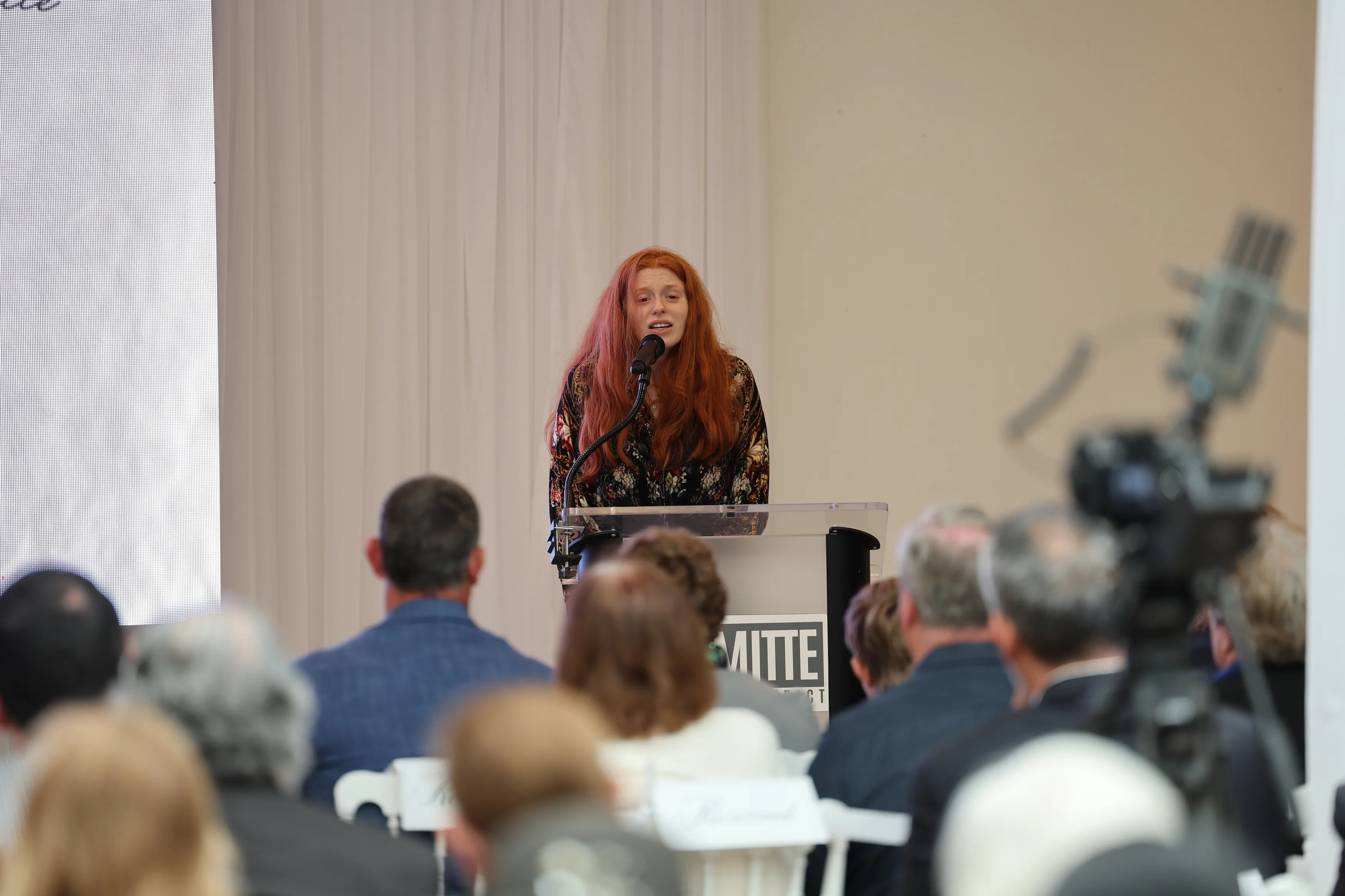 Lacianne Carriere speaks at a podium during a celebration of life for RJ Mitte.