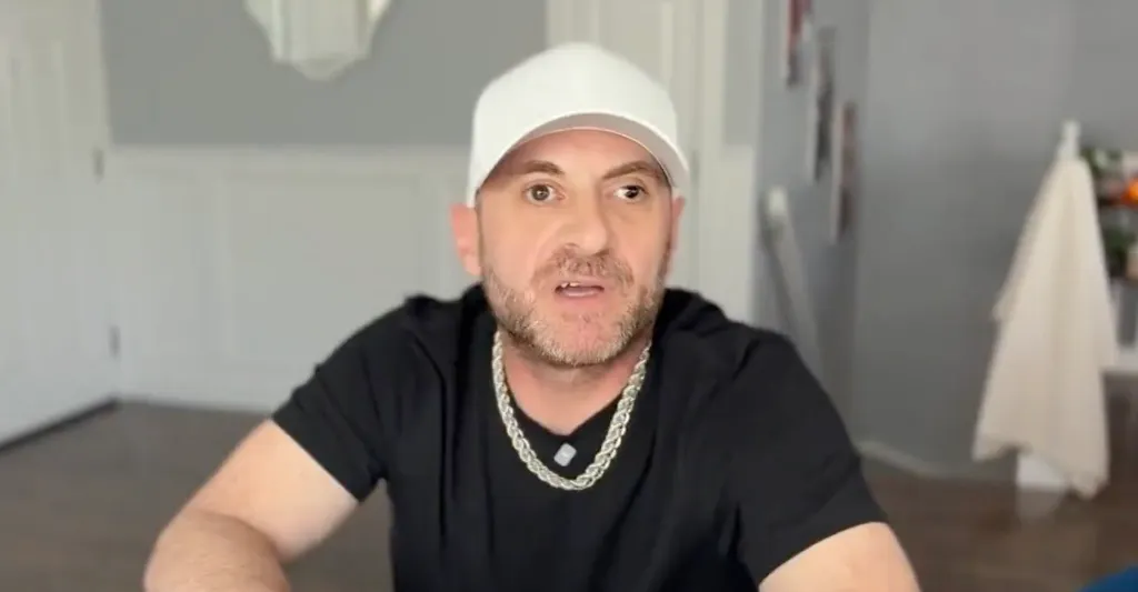 Bruce Capagli, wearing a white cap and black t-shirt.