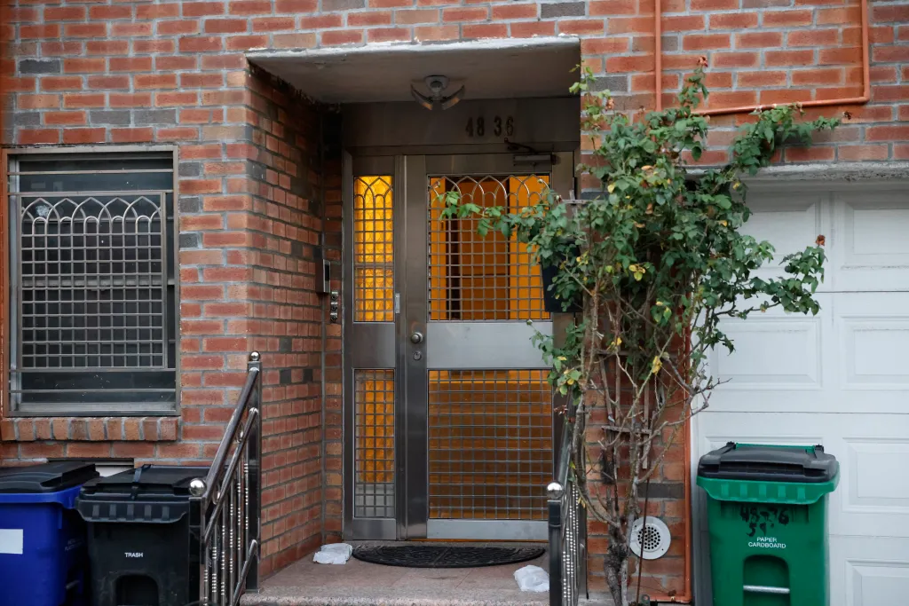 Exterior view of the brick walk-up building in Woodside, Queens, where Bryan Wong was found unconscious.