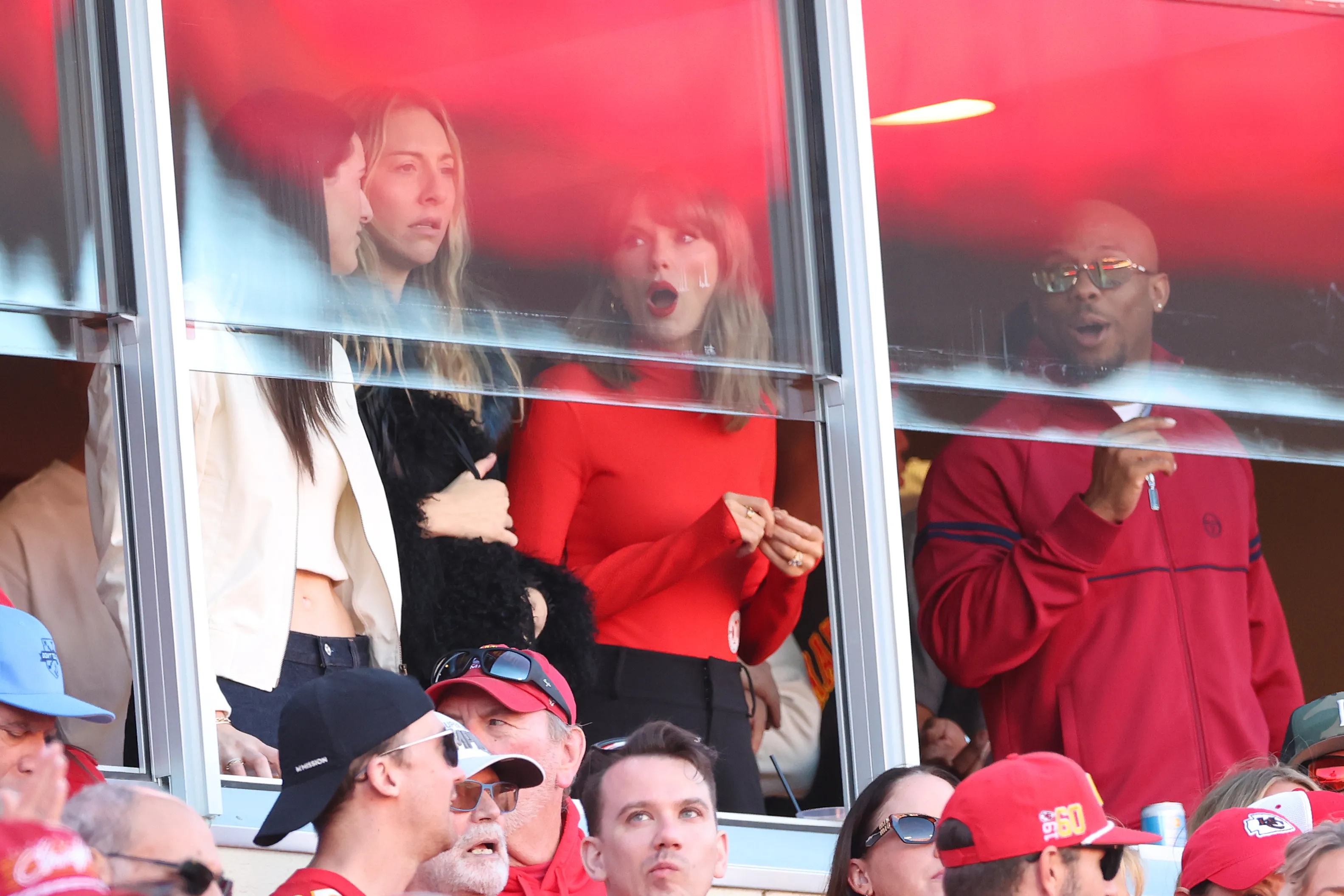 Caitlin Clark, Brittany Mahomes, and Taylor Swift react in a suite at Arrowhead Stadium.