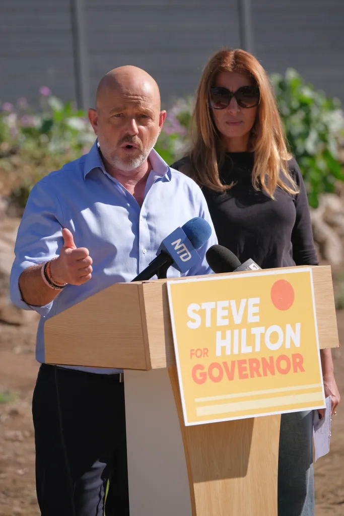 California gubernatorial candidate Steve Hilton speaks at a press conference at a podium with a 