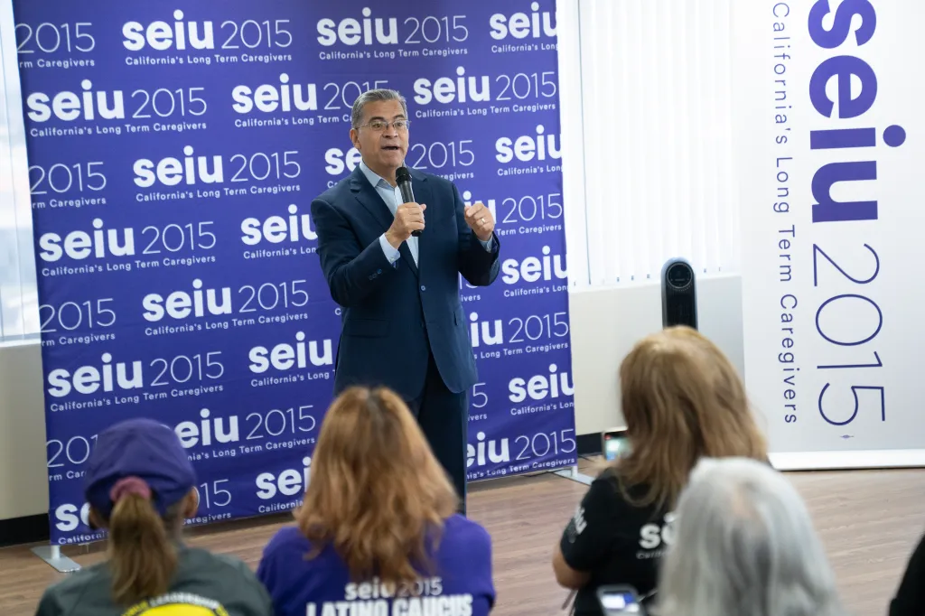 California gubernatorial candidate Xavier Becerra speaks into a microphone during a campaign event.